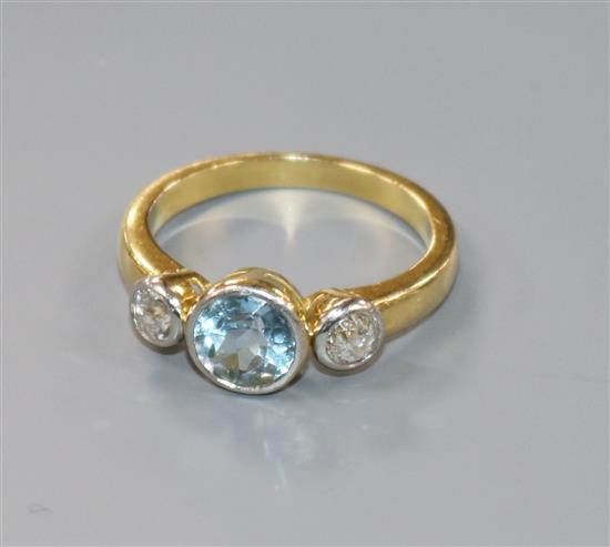 An 18ct gold, aquamarine and diamond set three stone dress ring, size Q.